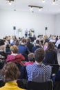 Group of People Sitting in hall During a Conference. Two Male Ho