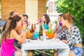 Group of people sitting having lunch together and drinking Royalty Free Stock Photo