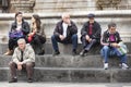 Group people sitting on marble steps, Catania, Sicily. Italy Royalty Free Stock Photo