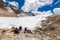 Group people sitting mountains glacier resting eating, Bolivia travel.