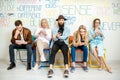 Group of people sitting in a row with smart phones indoors Royalty Free Stock Photo