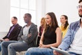 Group of people sitting at seminar, copy space