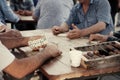 A group of people sitting at a table playing dominoes Royalty Free Stock Photo