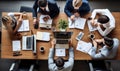 A group of people sitting at a table working on laptops