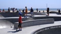 Group of people skateboarding at Venice beach in Los Angeles, United States