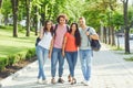 Group of people smiling on a city street in summer.