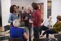 Group Of People Socializing After Meeting In Community Center Royalty Free Stock Photo