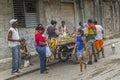 A group of people stand at a market stall of a vegetable street vendor in Havana`s famous old town Royalty Free Stock Photo