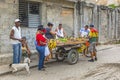 A group of people stand at a market stall of a vegetable street vendor in Havana`s famous old town quarter Havana Vieja Royalty Free Stock Photo