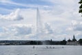 Group of people on stand up paddles around artificial geyser Royalty Free Stock Photo