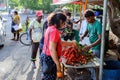 Group of People Standing Around a Fruit Stand Royalty Free Stock Photo