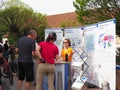 Group of people standing around a table, registering for a cycling-related event in Germany