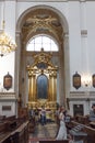 Group of people standing in awe in a grand cathedral during wedding ceremony in Poland, Krakow