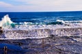 A group of people are standing on the beach, watching the waves Royalty Free Stock Photo