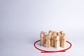 A group of people are standing in a circle on a white background. Wooden figures. Community, party. Statistics and public opinion,