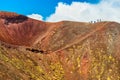 A group of people standing on the edge of the volcano crater, Mount Etna, Sicily, Italy Royalty Free Stock Photo