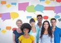 Group of people standing in front of colorful chat bubbles Royalty Free Stock Photo