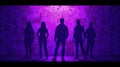 A group of people are standing in front of a purple wall Royalty Free Stock Photo