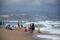 Group of people standing in the sea foam in Jeanne D`arc beach.