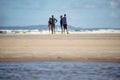 group of people standing talking on Guaibim beach in Valenca, Bahia