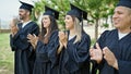 Group of people students graduated clapping applause at university campus