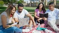 Group of people students sitting on grass studying at park Royalty Free Stock Photo