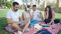 Group of people students sitting on grass studying at park Royalty Free Stock Photo