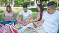 Group of people students using laptop and smartphones studying at park Royalty Free Stock Photo