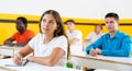 Group of people studying together at table. Focus on euroepan woman Royalty Free Stock Photo