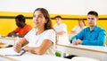 Group of people studying together at table. Focus on euroepan woman Royalty Free Stock Photo