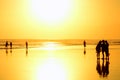 Group of people at sunset on the beach. Seminyak, Bali, Indonesia Royalty Free Stock Photo