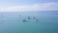 Group of people swim on SUP Board. Clip. Beautiful seascape with people resting on water with SUP boards. Top view of