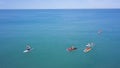 Group of people swim on SUP Board. Clip. Beautiful seascape with people resting on water with SUP boards. Top view of