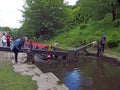 A group of people taking a narrowboat though a lock gate on the rochdale canal in hebden bridge west yorkshire Royalty Free Stock Photo