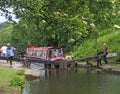 a group of people taking a narrowboat though a lock gate on the rochdale canal in hebden bridge west yorkshire Royalty Free Stock Photo