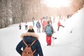 Group of people in a tour at a snowy mountain. Winter fun excursion