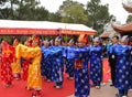 Group of people in traditional costume give gifts to the holy