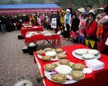 Group of people in traditional costume give gifts to the holy