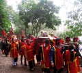 Group of people in traditional costume give gifts to the holy