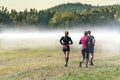 Group of people trail running outdoors in nature