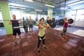 Group of people training with barbells in gym Royalty Free Stock Photo