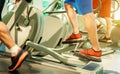 Group of people training on tapis roulant inside gym club - Fitness man running and using eliptical cross trainer - Wellness and