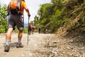 A group of people trekking on dirt road in Nepal