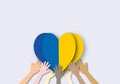 Group of people united diversity holding Ukrainian flag heart shape on white background, Concept for Peace and stop the war. Royalty Free Stock Photo