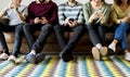 Group of people using mobile phone on couch Royalty Free Stock Photo