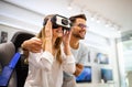 Group of people using virtual reality headset at exhibition, show. VR technology simulation concept