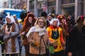 People in fun costumes celebrating at the carnival Fasching on Rose Monday parade in the city