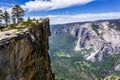 A group of people visiting Taft Point, a popular vista point; El Capitan, Yosemite Valley and Merced River visible on the right; Royalty Free Stock Photo