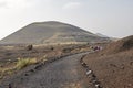 Group of people walking down a dirt road