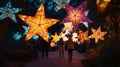 a group of people walking down a path with lighted stars Royalty Free Stock Photo
